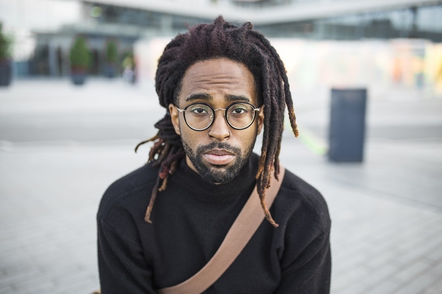 long dreadlocks with thick stubble beard