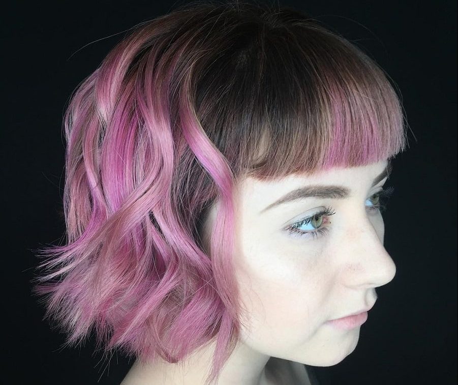 wavy bob and bangs with pink highlights