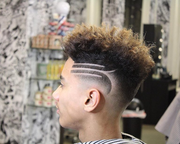 Modern curly hairstyle with shaved sides.