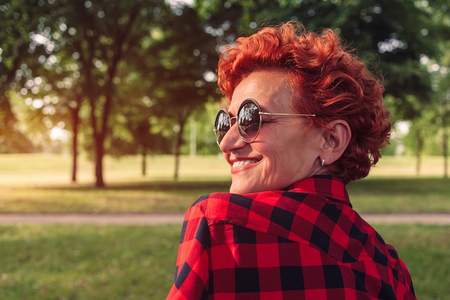 older woman with red short curly hair