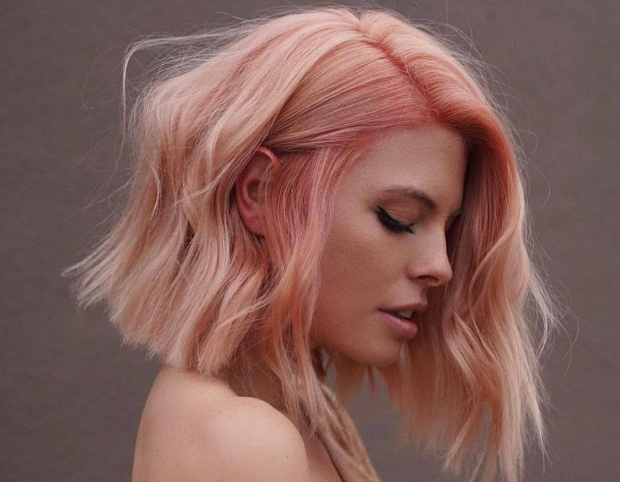 wavy asymmetrical bob with pastel pink hair