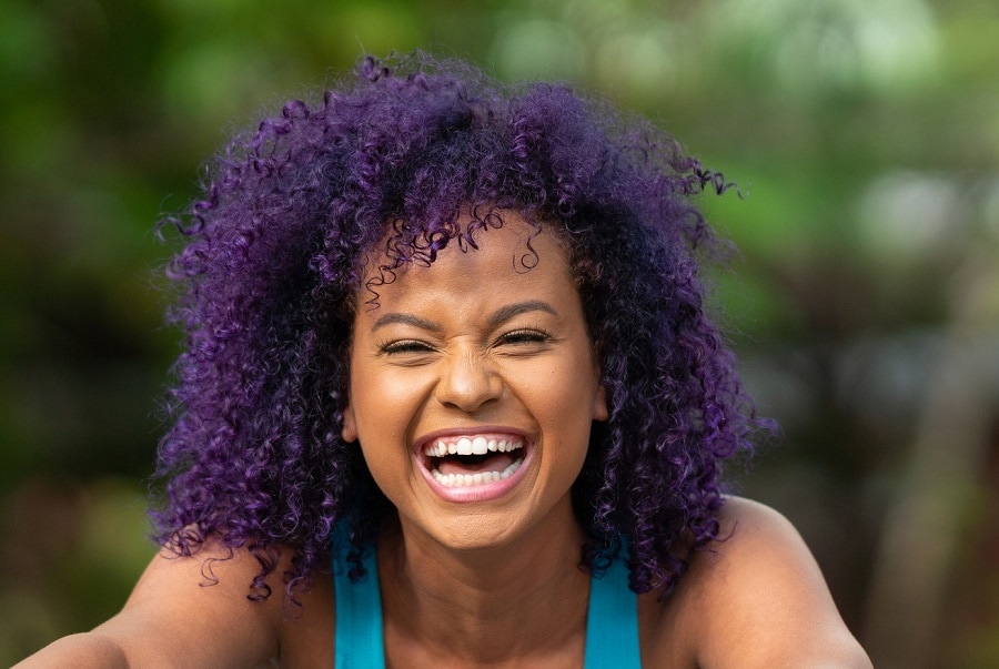 black woman with dark purple afro hair