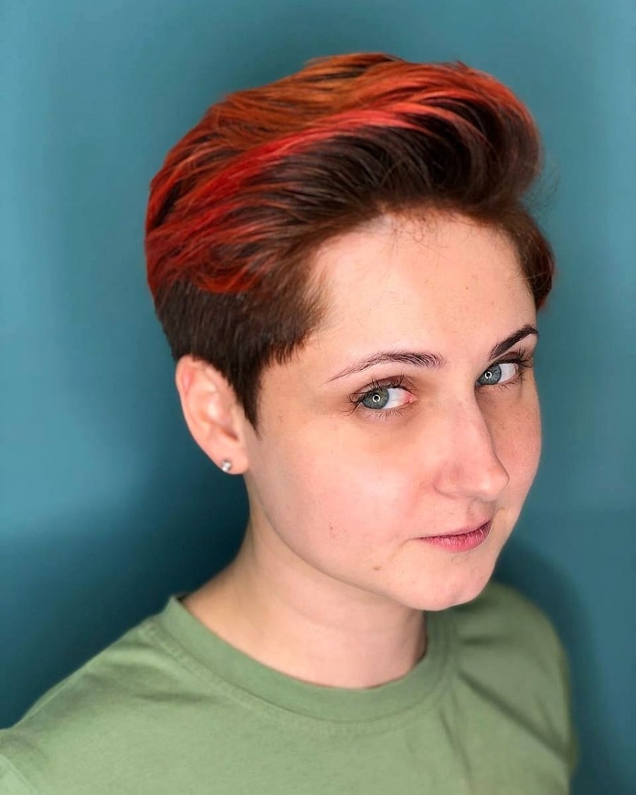 woman's pixie cut with red highlights