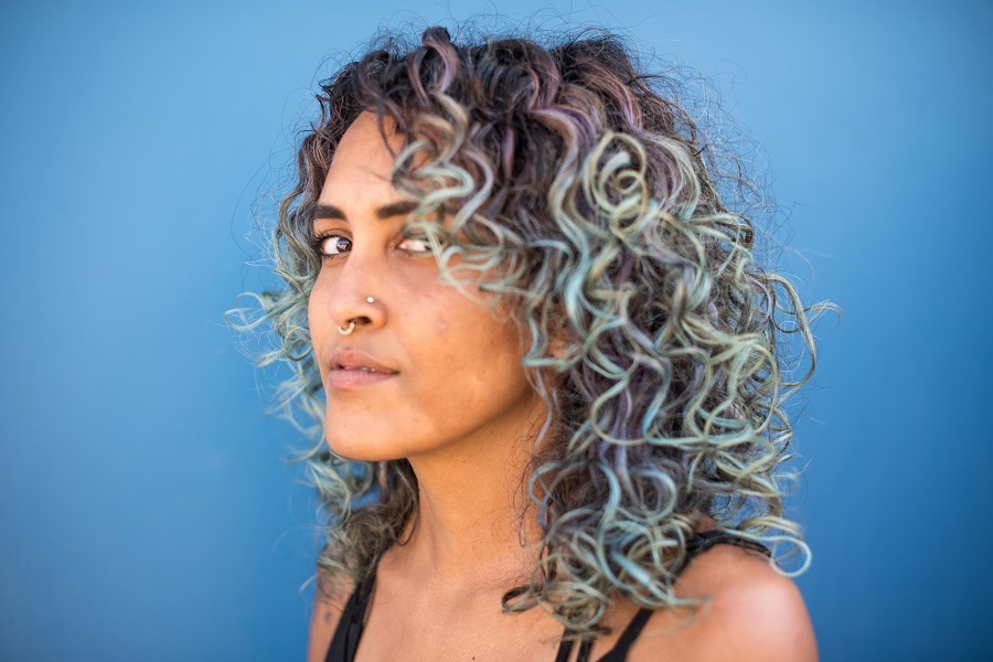 curly hair with pastel blue highlights for tan skin