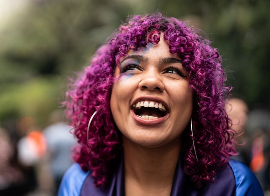 mixed girl with curly magenta pink hair