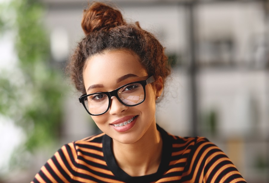 mixed girl with curly top knot