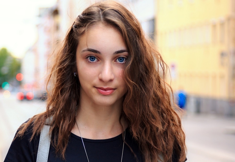 teenage girl with brown hair and blue eyes