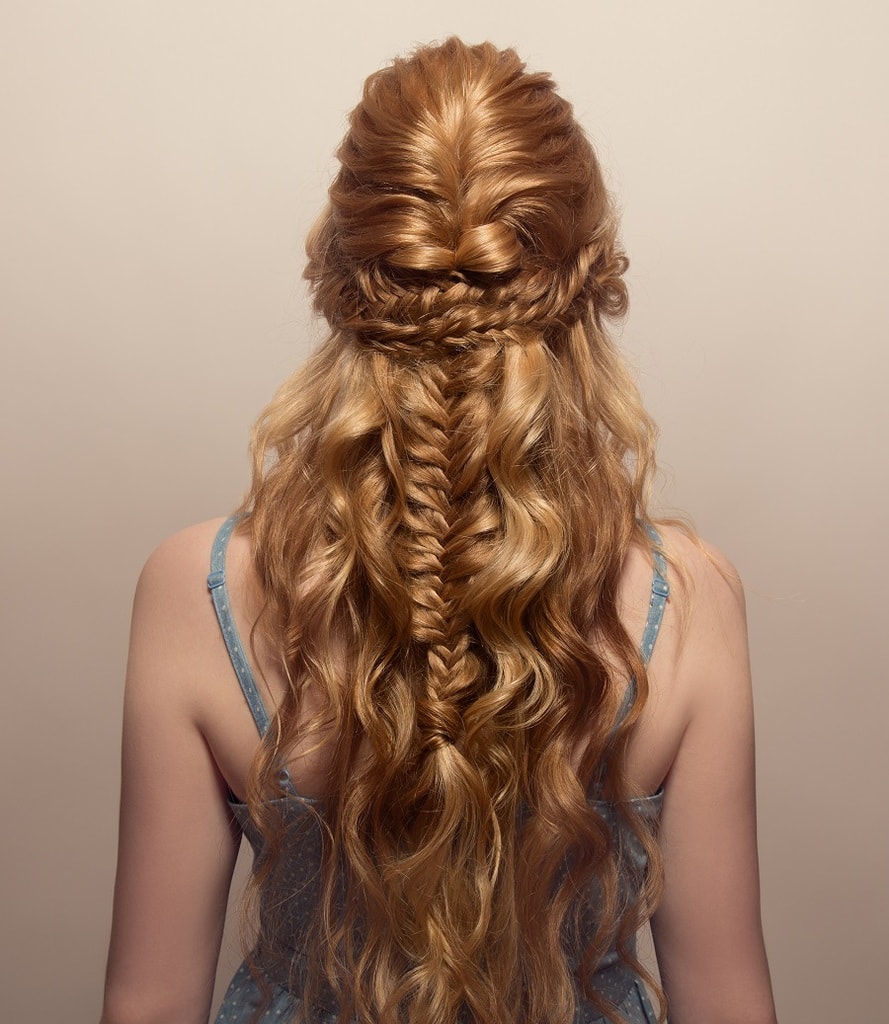 fishtail braided hairstyle with blonde curly hair