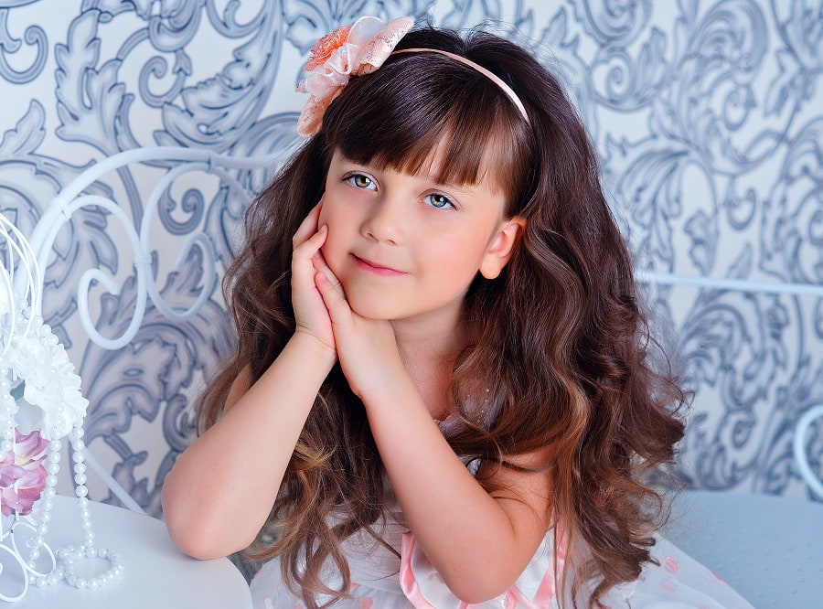 flower girl brunette hairstyle with bangs