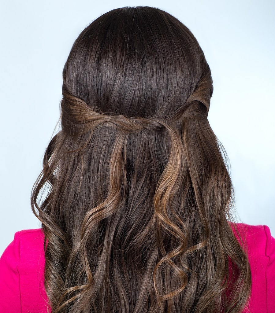 half up hairstyle with long dark brown wavy hair