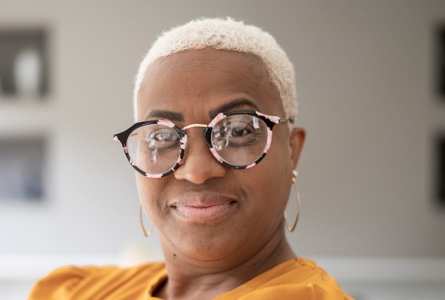 short afro hairstyle for women over 50 with glasses