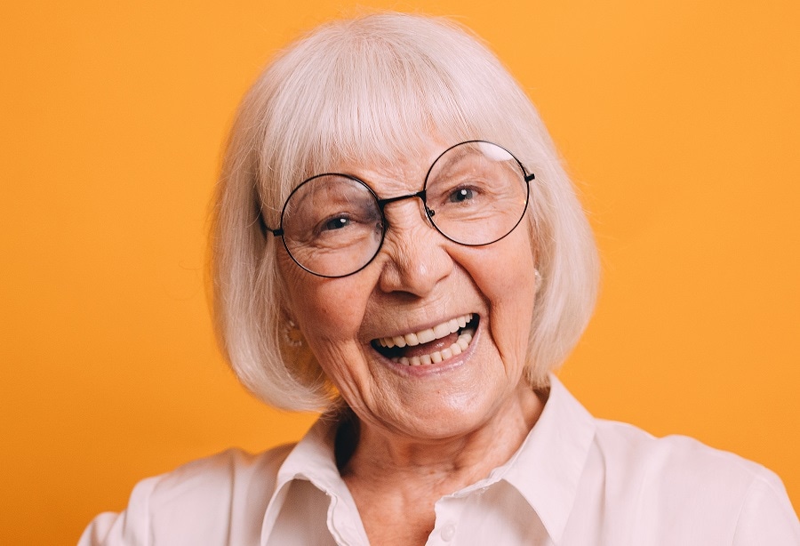 short blonde bob with bangs for over 70 with glasses
