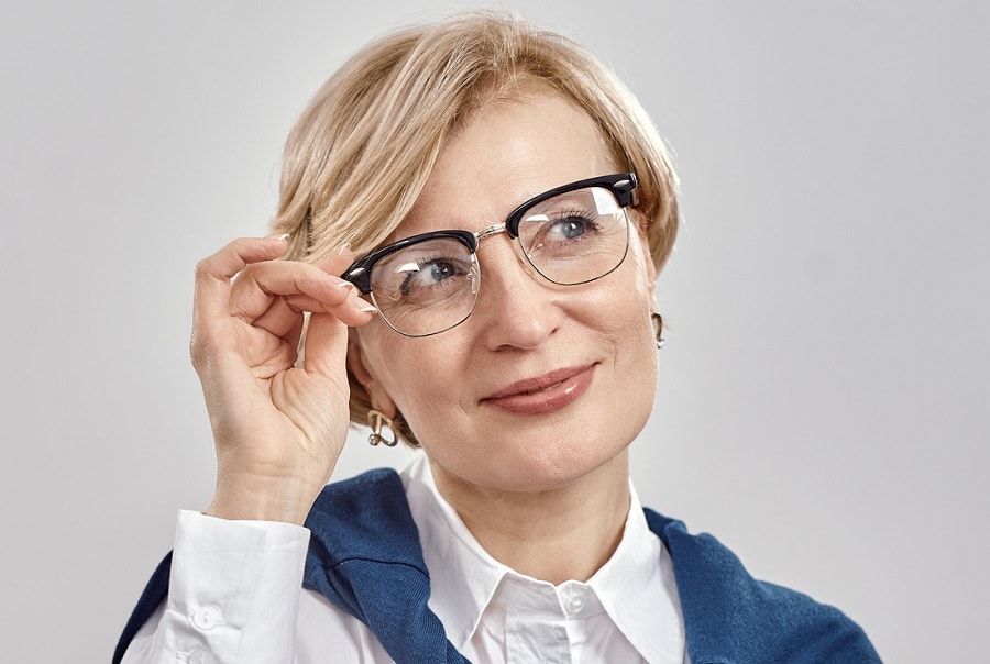 short layered blonde hairstyle over 50 with glasses