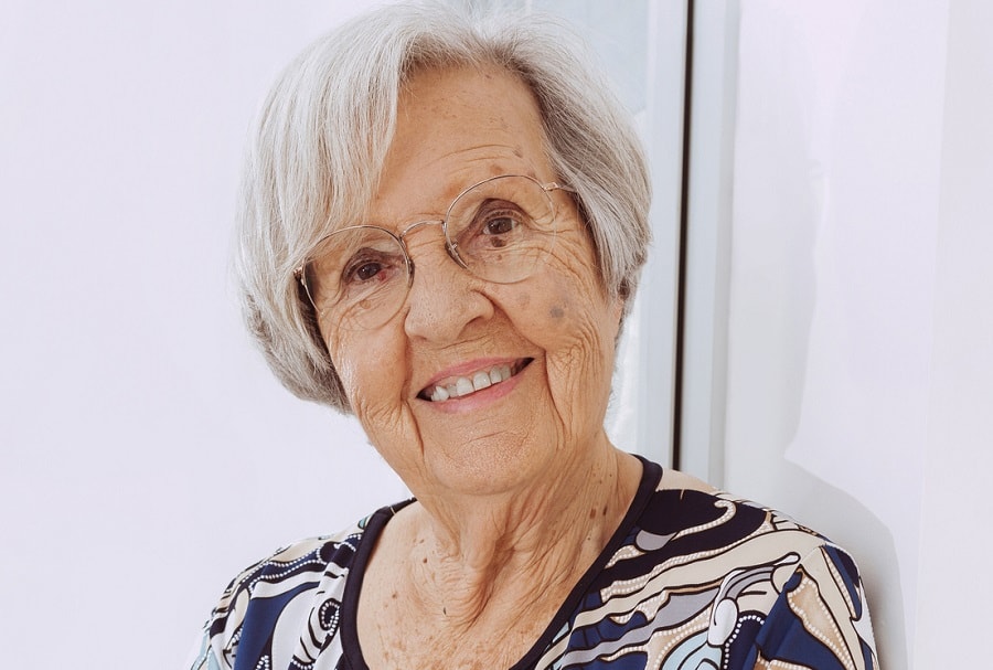 short layered hairstyle for over 70 with glasses