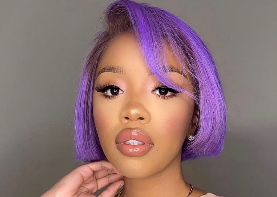 black girl with short purple hair and side bangs