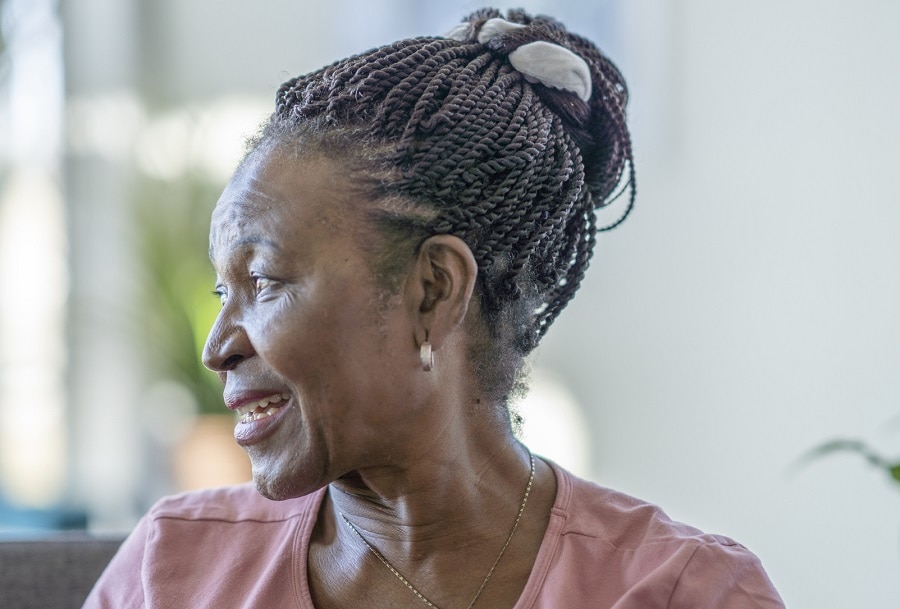 black woman over 70 with braided updo hairstyle