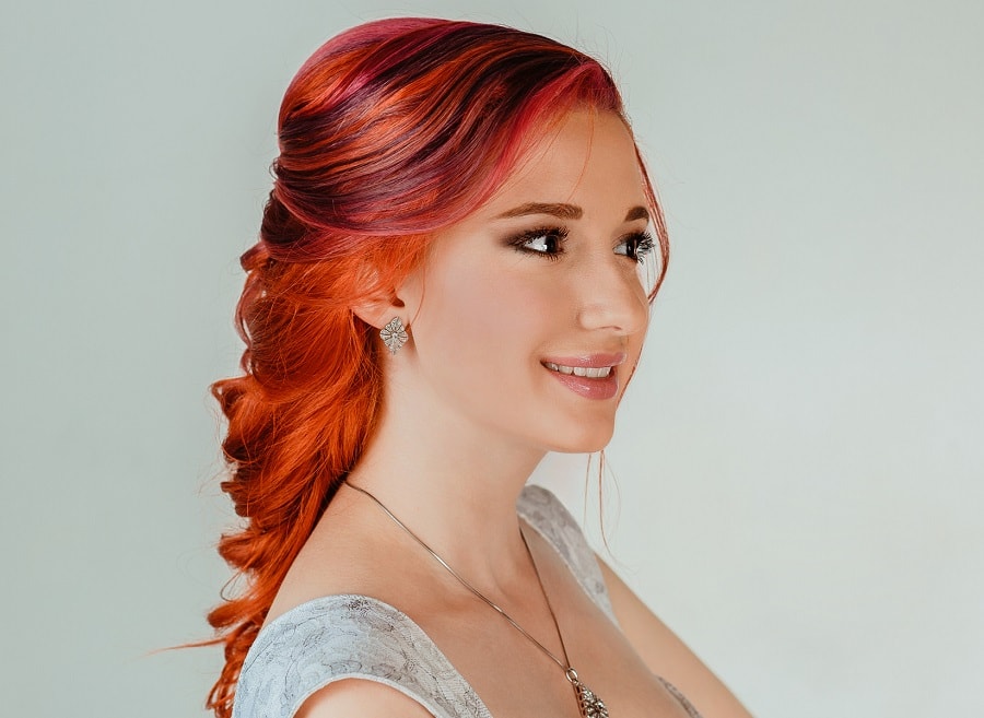 half up hairstyle with red highlights