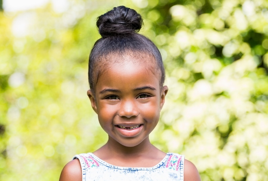 little black girl with high bun hairstyle