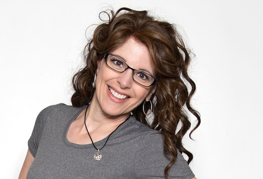 older woman with long curly brunette hair