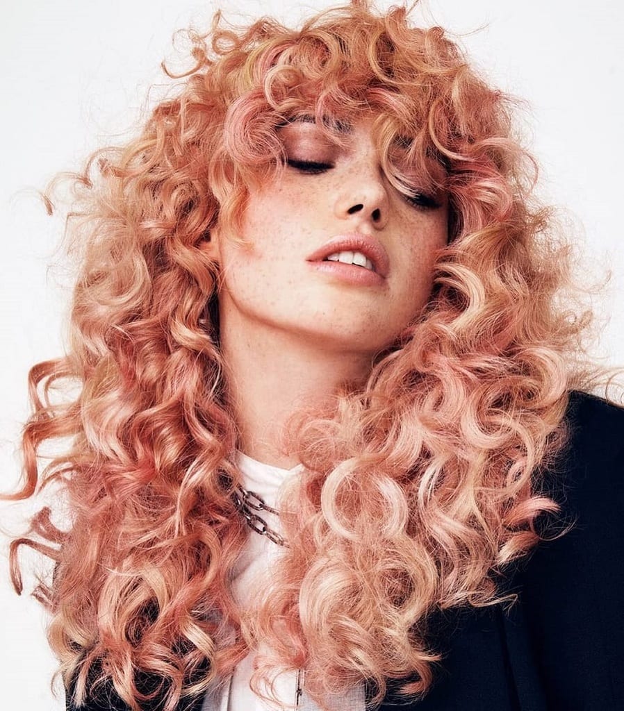 pastel pink perm hair with bangs