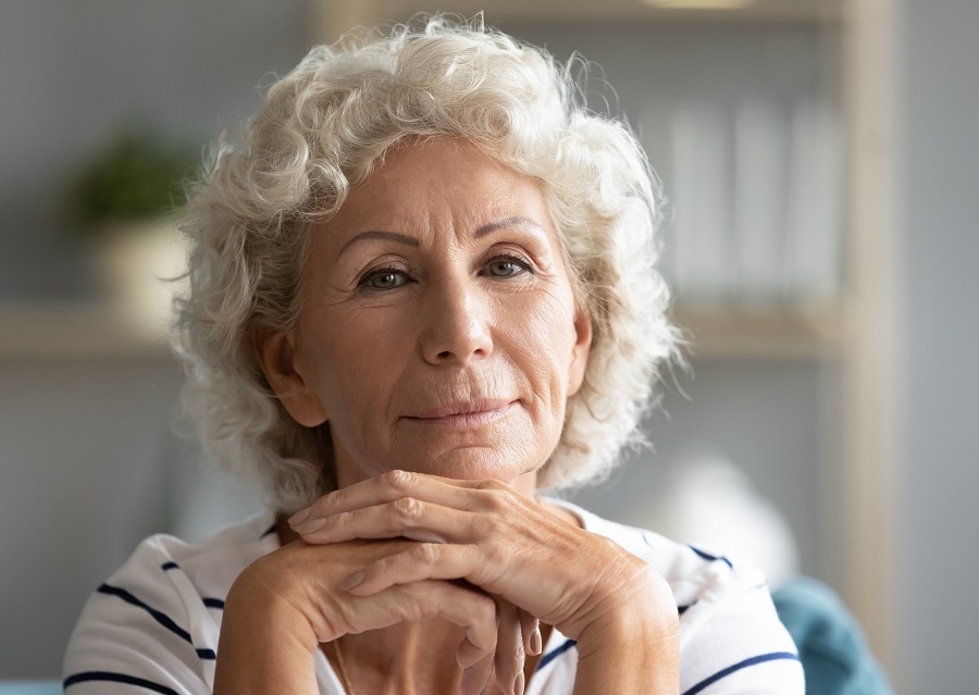 woman over 70 with curly white blonde hair