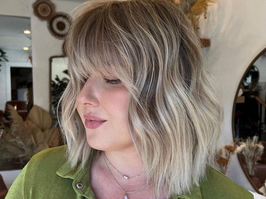 messy ash blonde hair with bangs