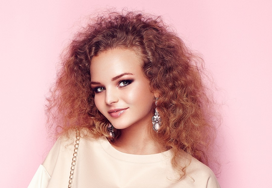 frizzy curly hairstyle with boat neckline