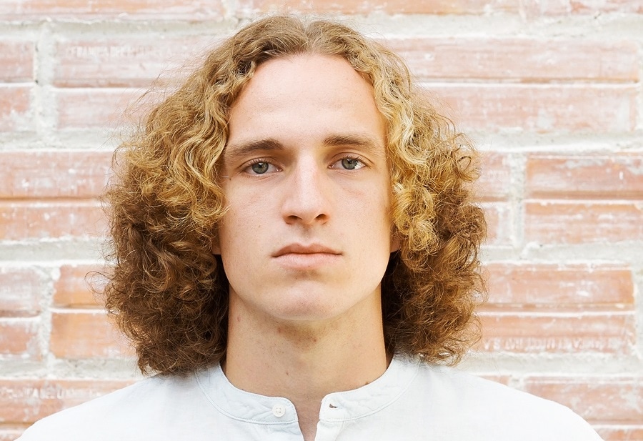 guy with middle part long blonde curls