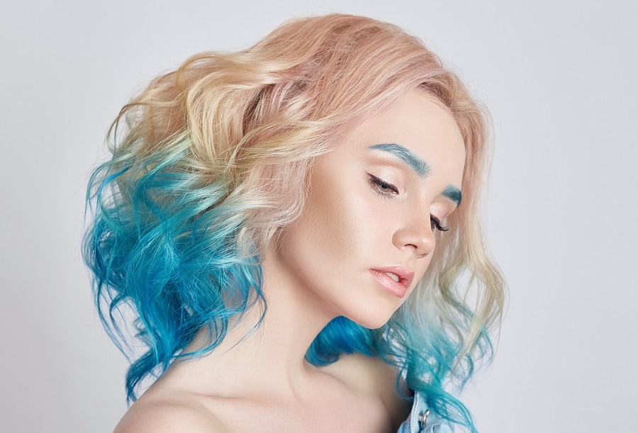 wavy blonde hair with pastel blue dip dye