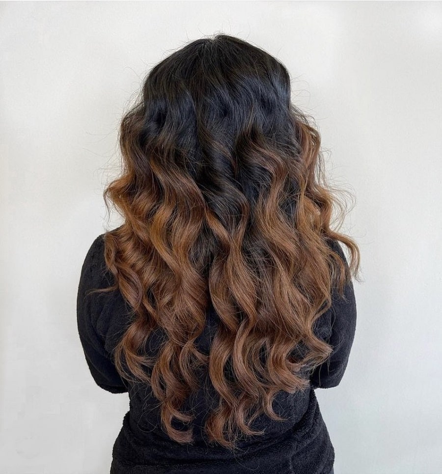 thick curly hair with caramel highlights