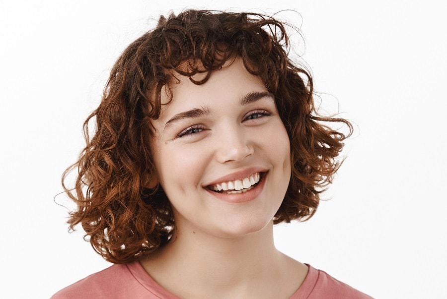 woman with short curly bangs
