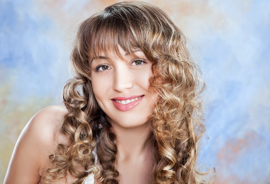 curly light brown hair with bangs and highlights