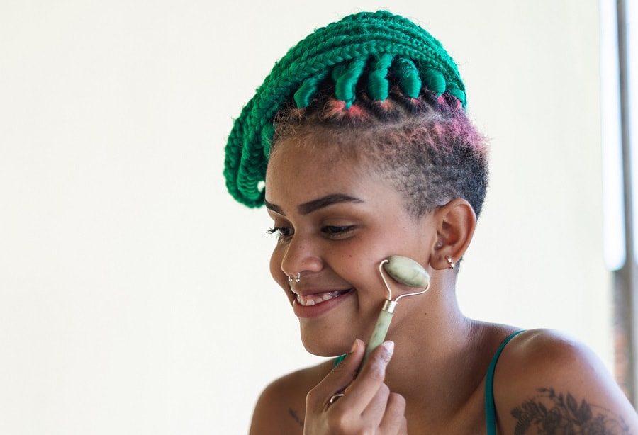 green braided hairstyle with shaved sides