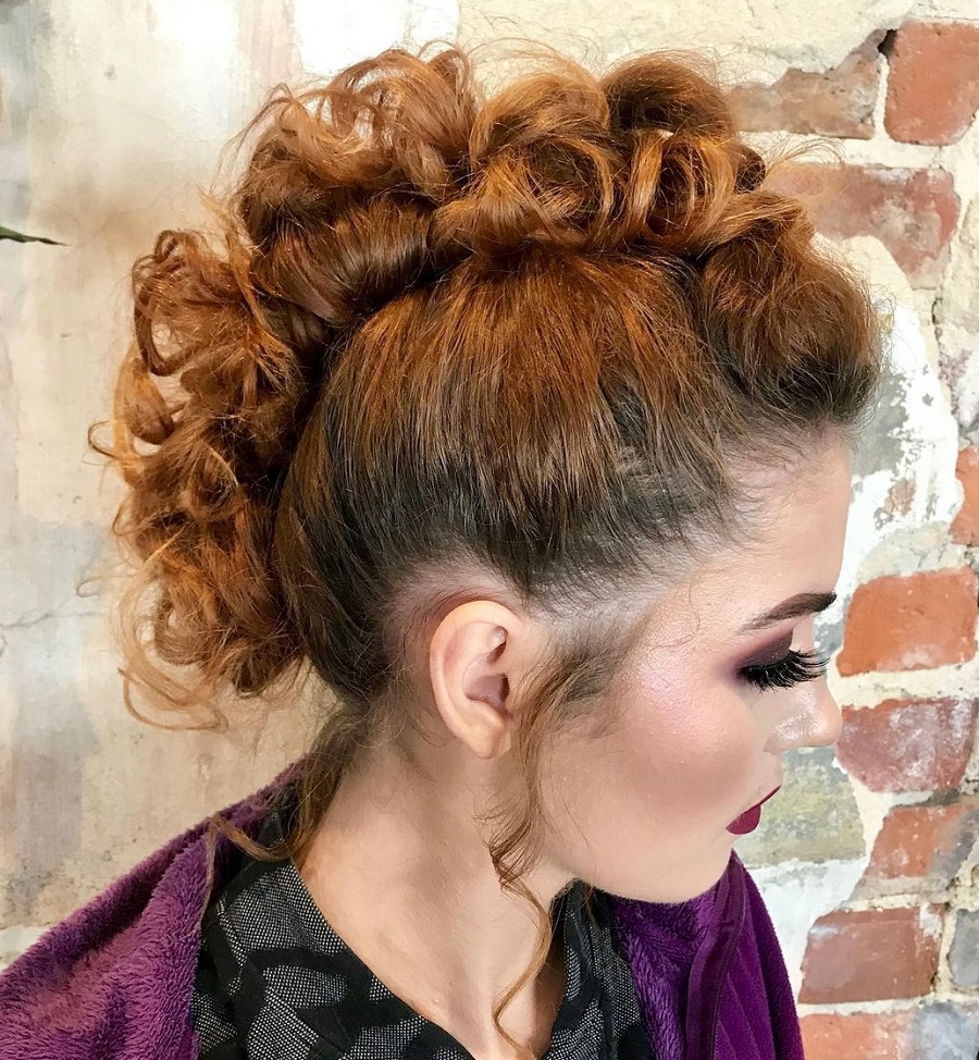 woman with curly brown mohawk updo