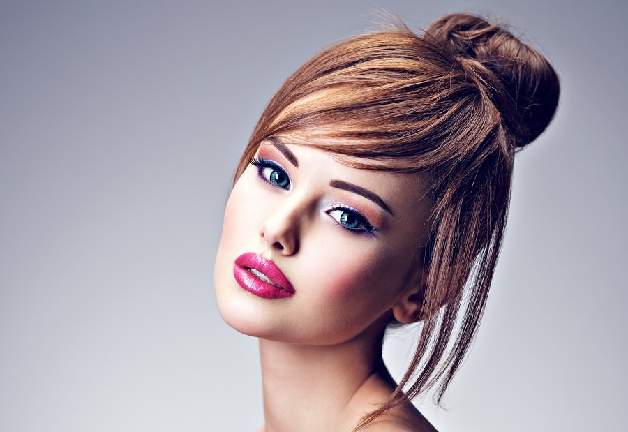 high bun with side swept bangs