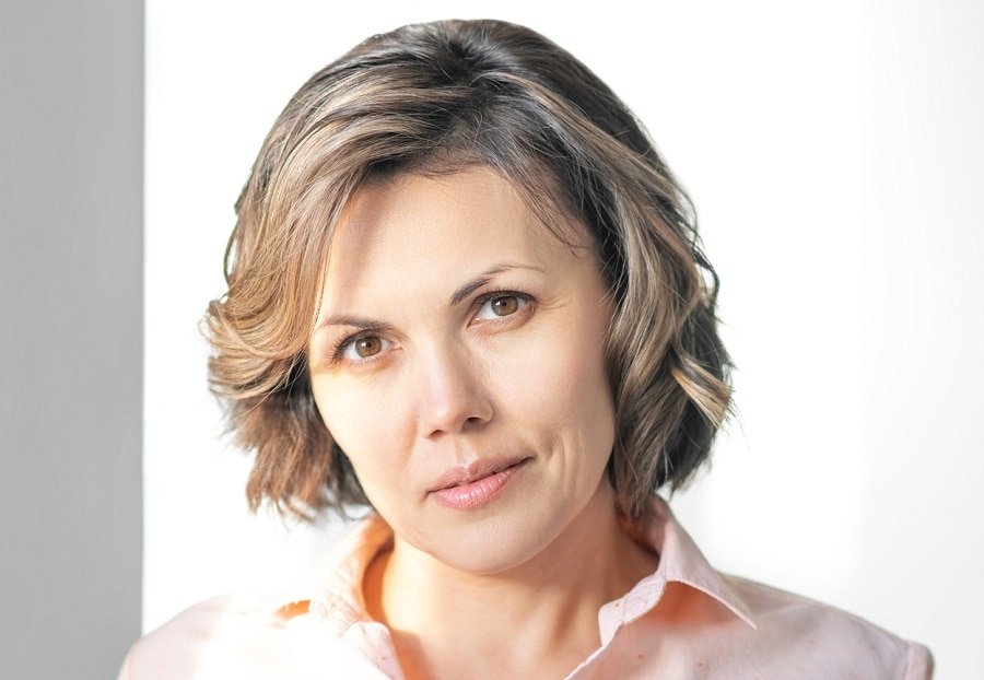 mature woman with dark brown bob and highlights