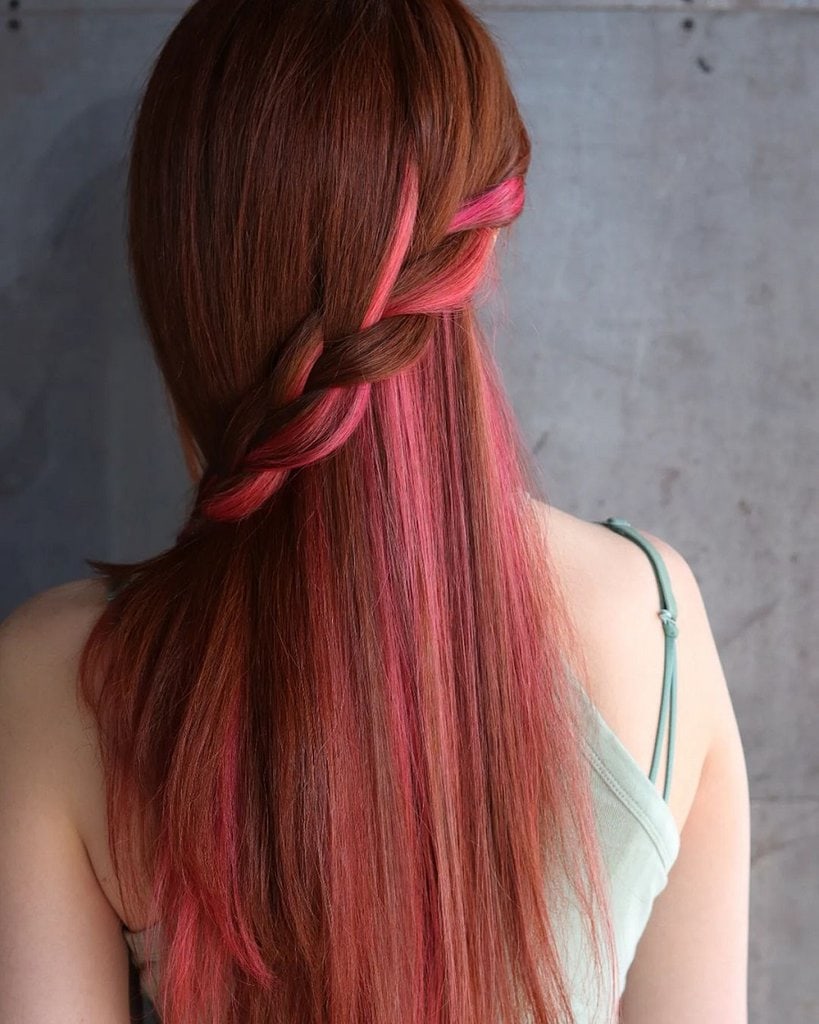 braided hairstyle with pink highlights