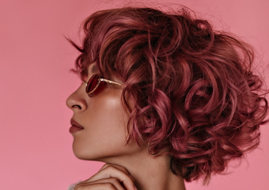 short curly hair with pink highlights