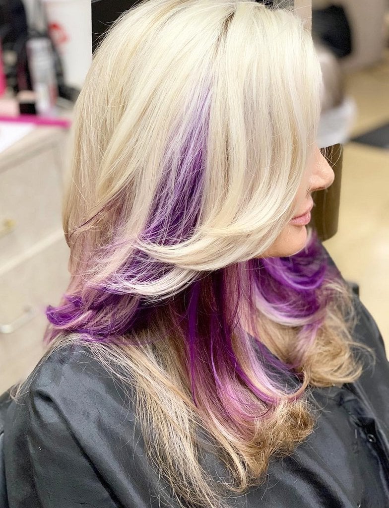 layered blonde hair with purple underneath