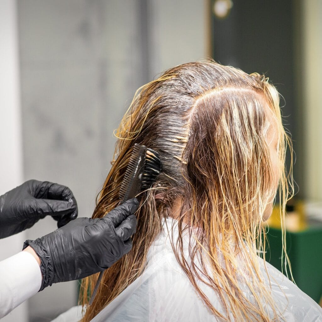 applying grey dye on brassy hair
